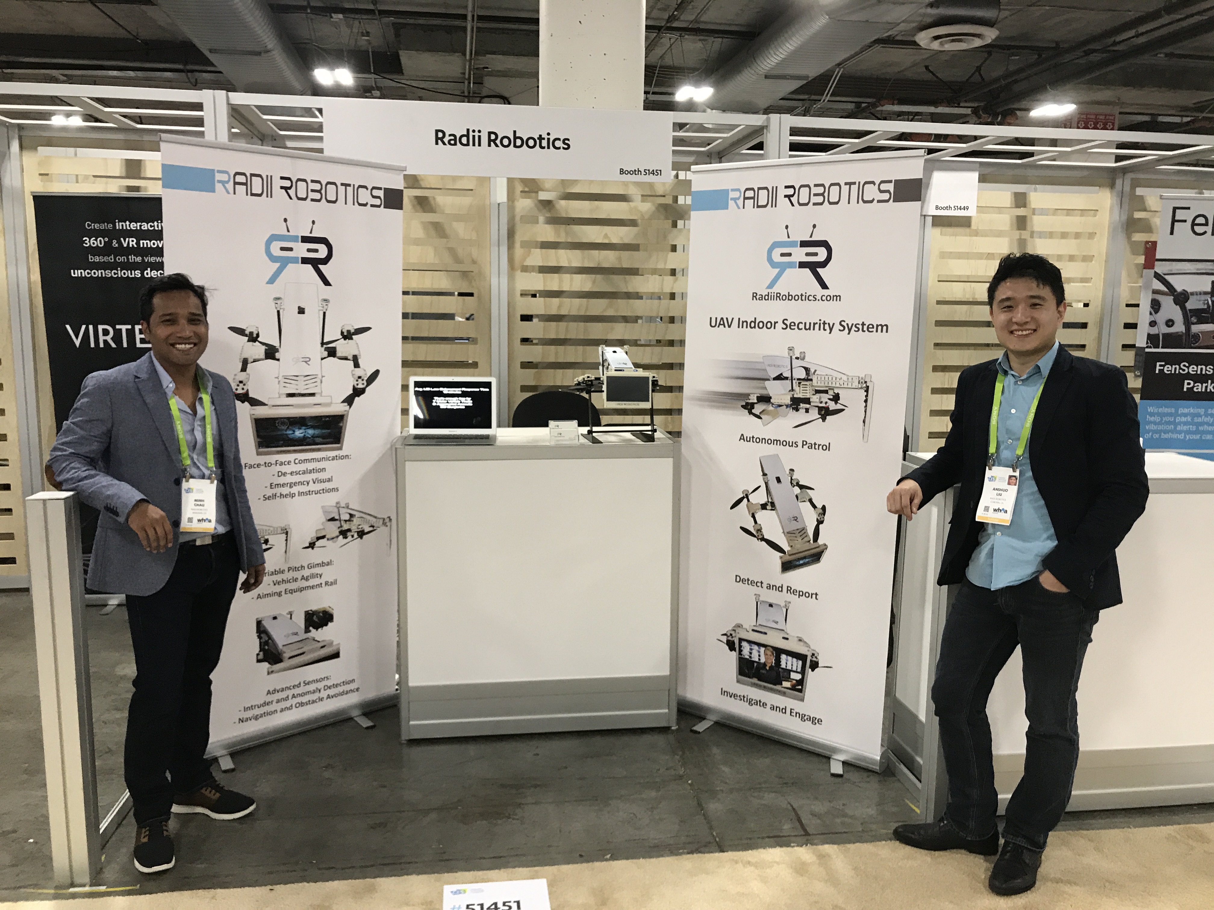 Two team members standing at the Radii Robotics trade-show booth.