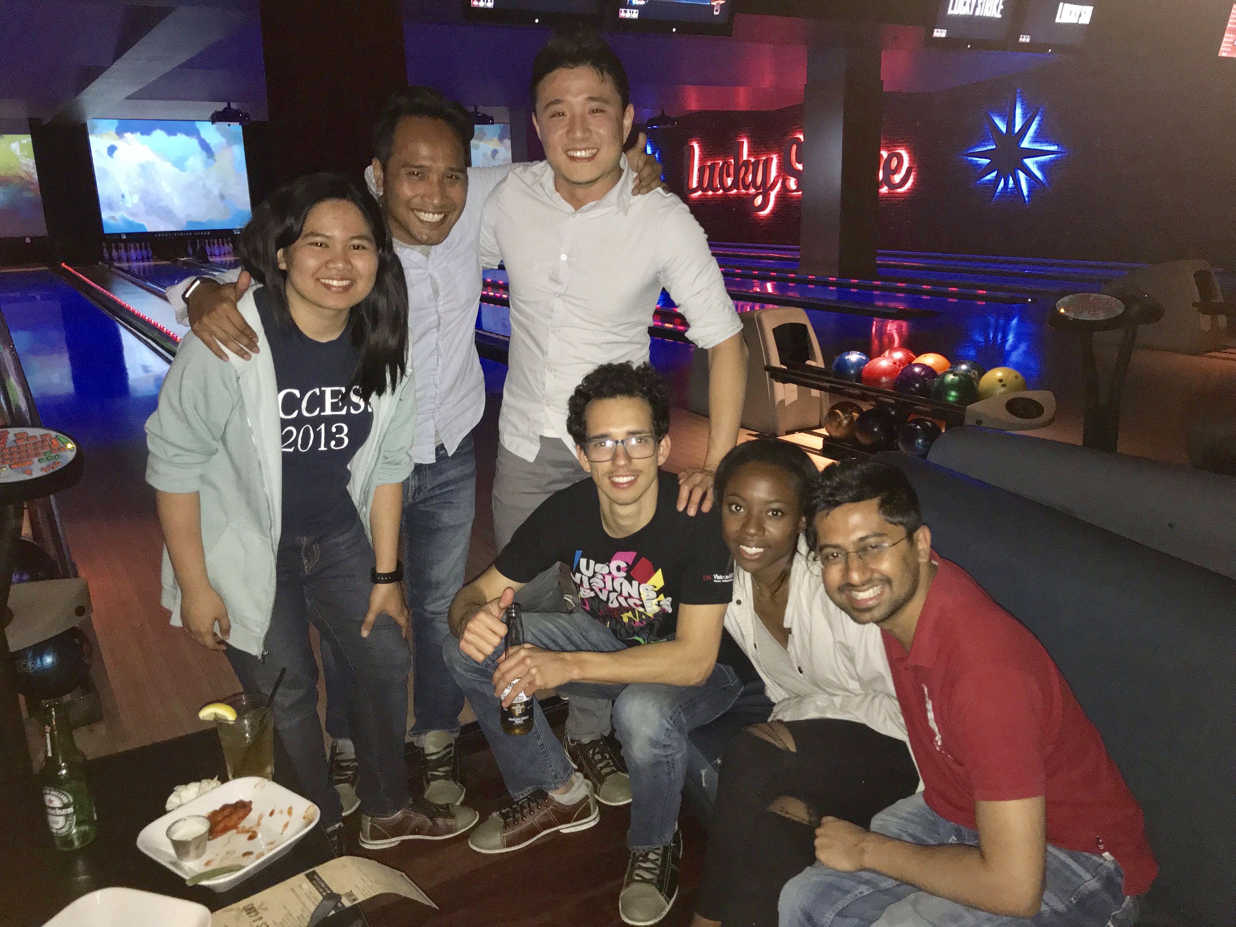 Startup team gathered together at a bowling venue.