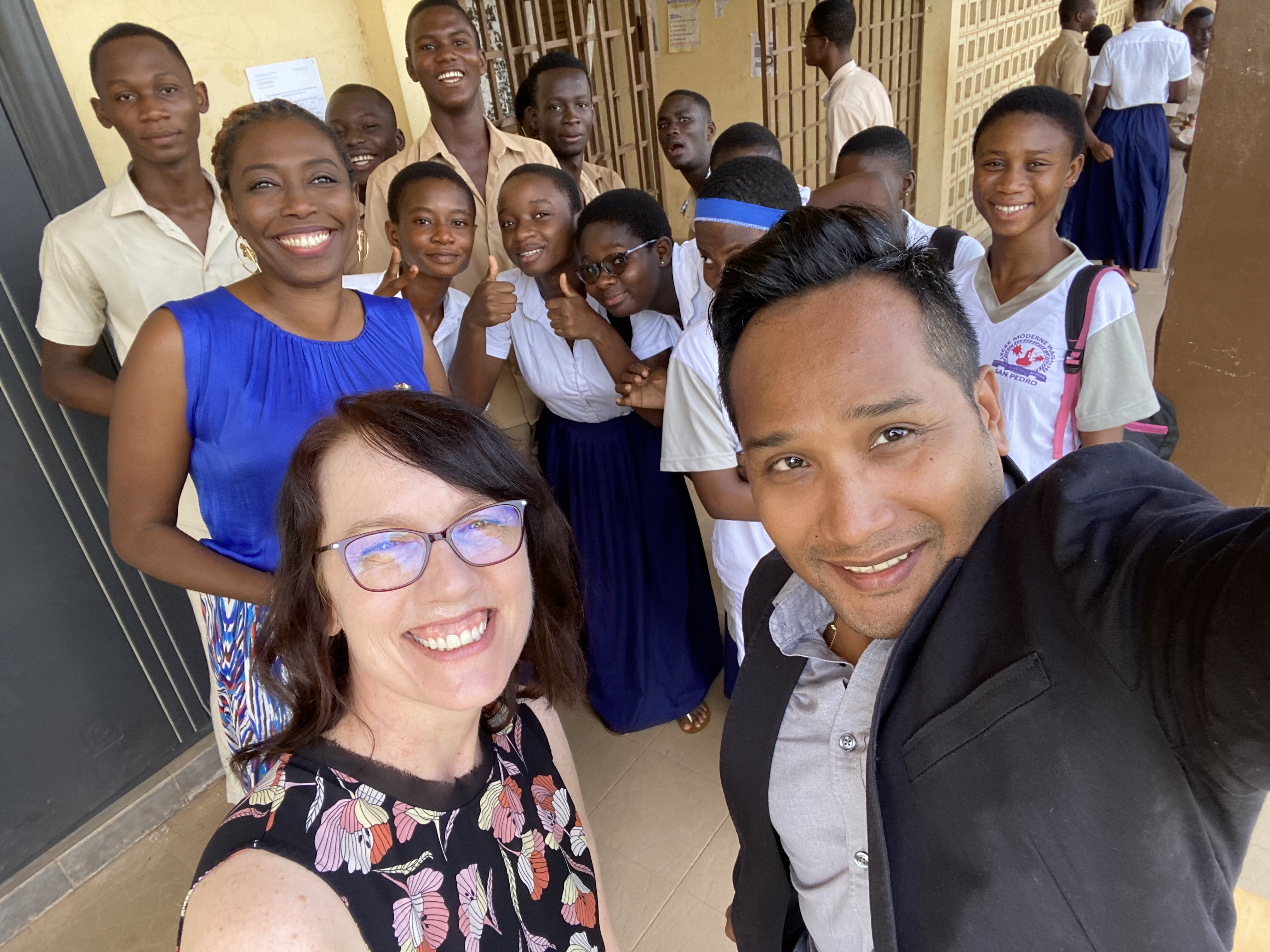 Group selfie with students gathered together at a school.