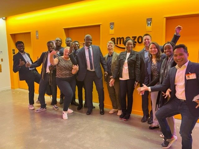 Group of development and technology partners gathered at an Amazon facility.