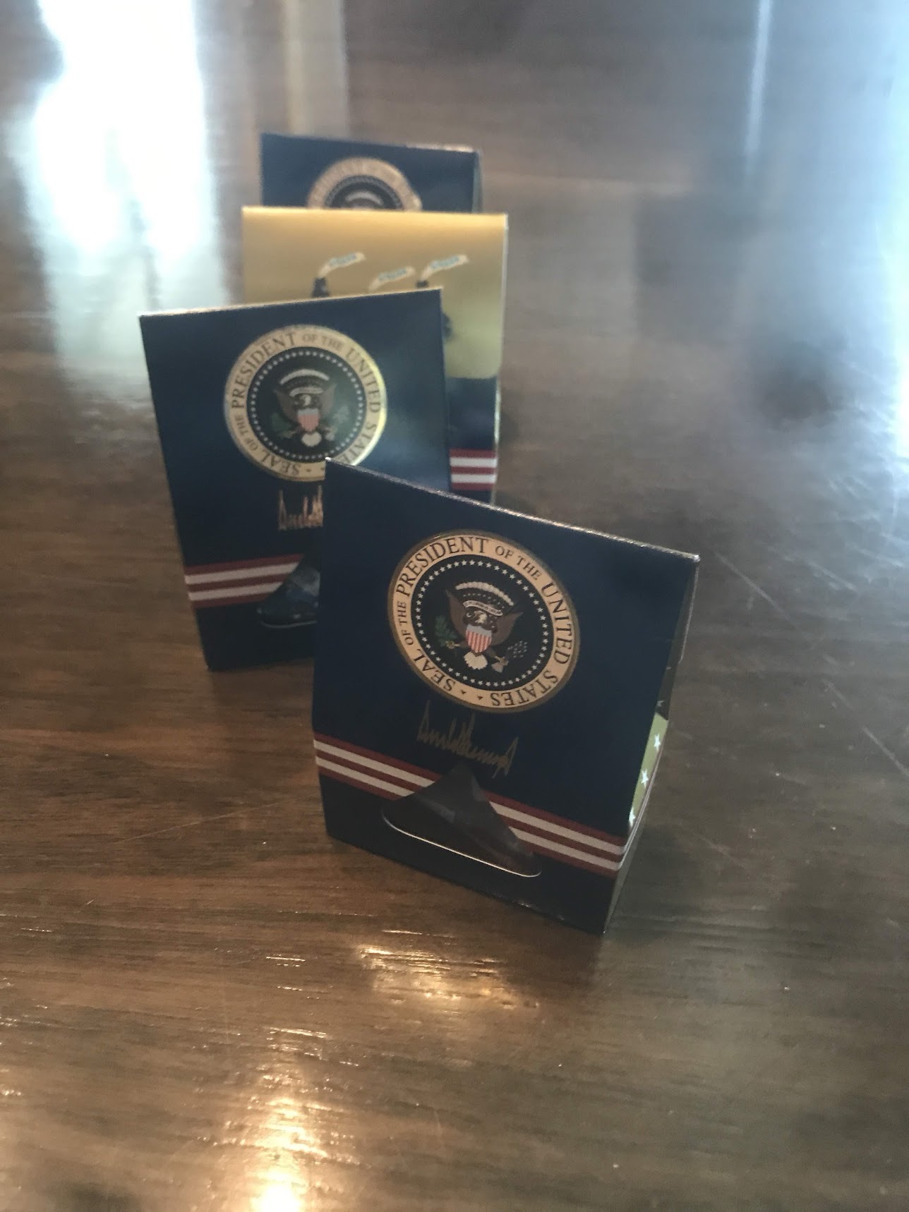 Several presidential-themed keepsakes arranged in a row on a wooden table.