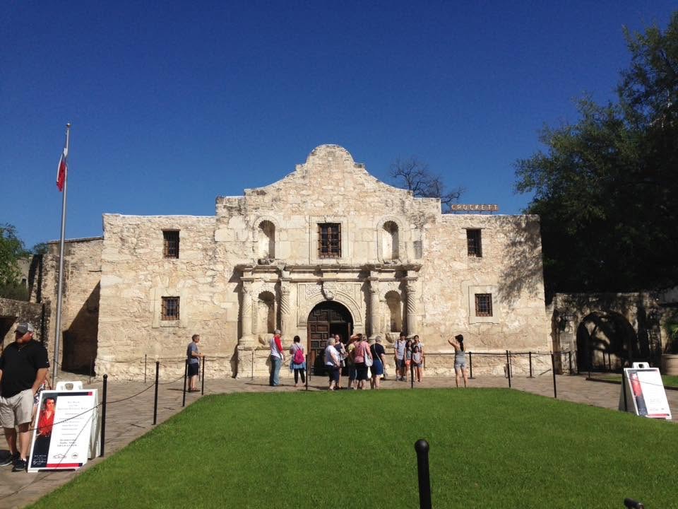 Front view of the Alamo beneath a clear blue sky.