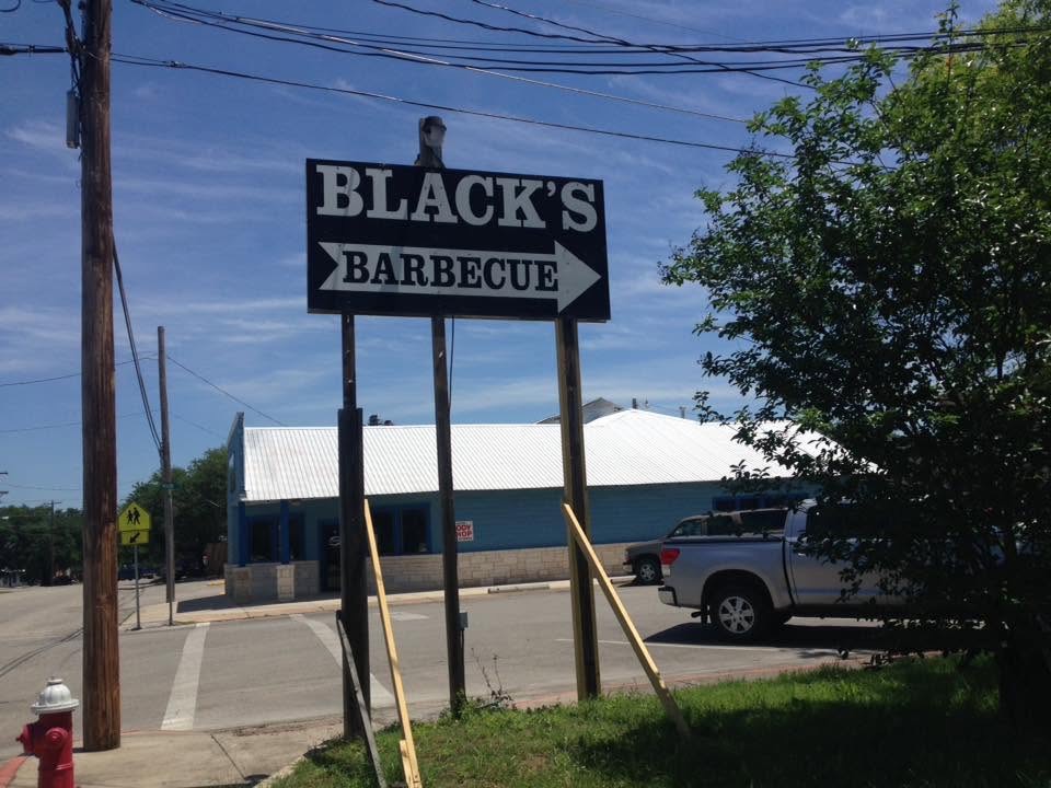 Roadside sign directing visitors to Black’s Barbecue.