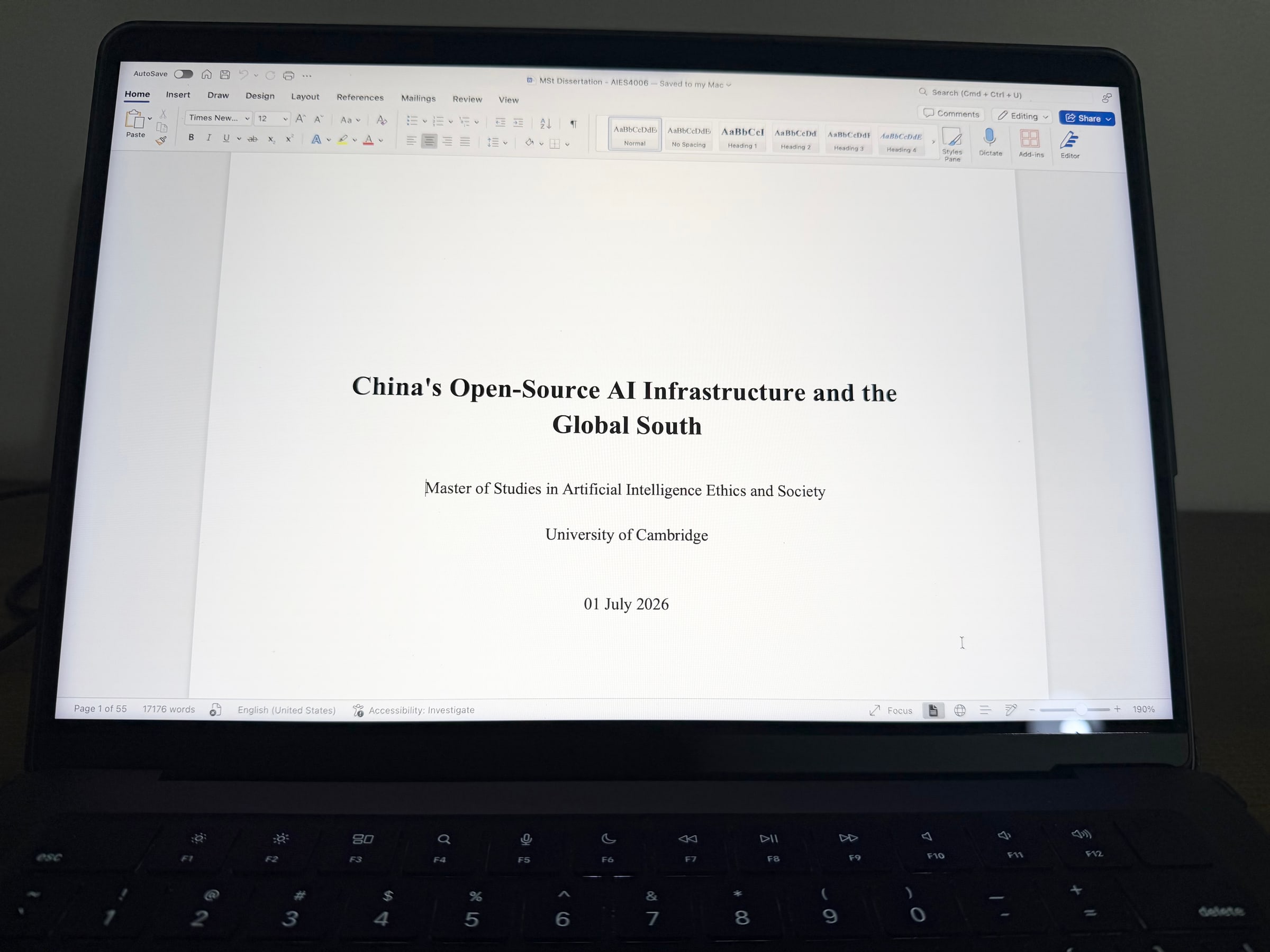 Laptop displaying the title page of a University of Cambridge dissertation.