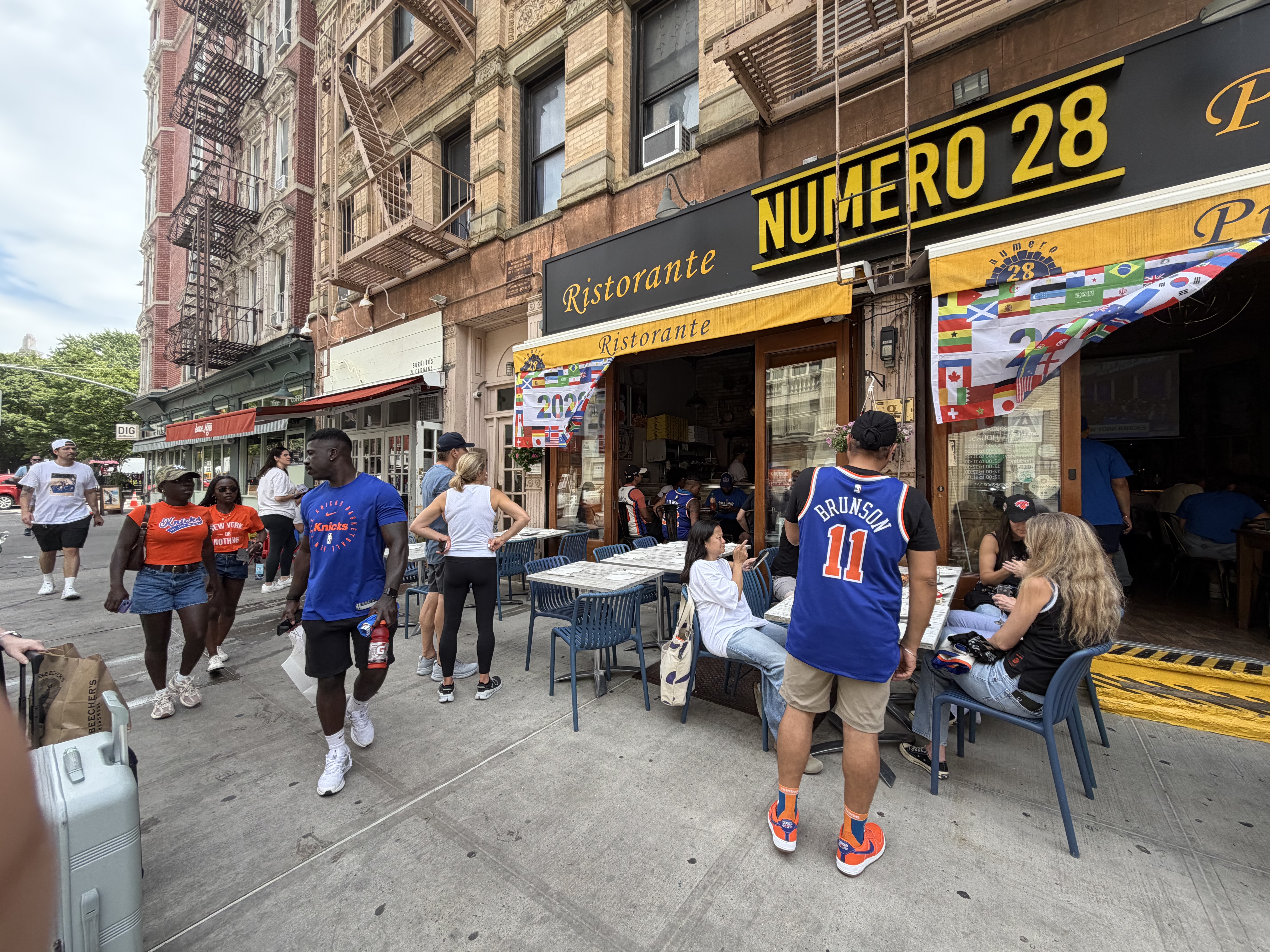 Knicks fans gathered outside a restaurant decorated for the championship celebration.