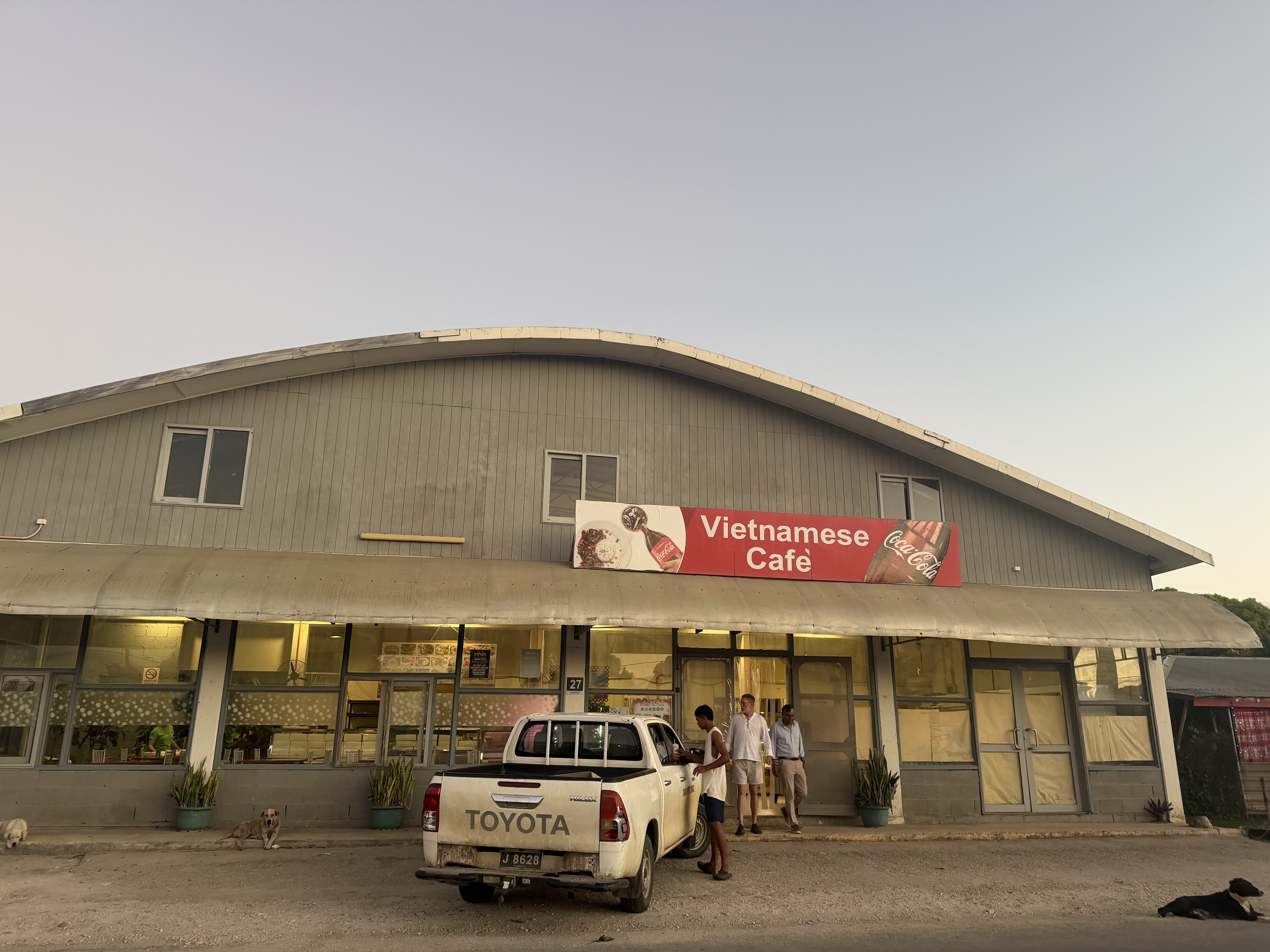 The Vietnamese Cafe in Tonga with a pickup truck parked outside.